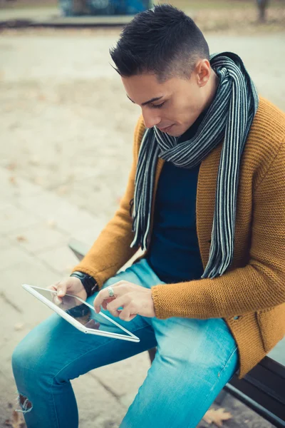 Handsome man in park using tablet — Stock Photo, Image