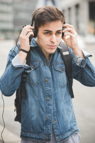 Młody człowiek ze słuchawkami słuchający muzyki — Zdjęcie stockowe