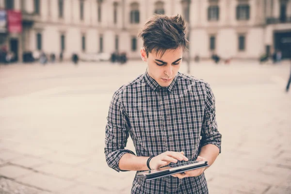 Joven hombre guapo en la ciudad con la tableta — Foto de Stock