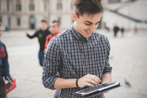 Jovem homem bonito na cidade com tablet — Fotografia de Stock