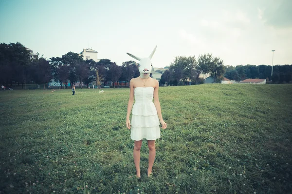 Rabbit mask absurd beautiful young woman with white dress — Stock Photo, Image