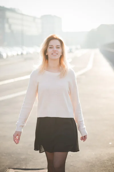 Mooie blonde vrouw in stad — Stockfoto