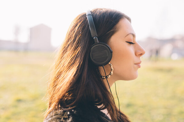 young beautiful woman listening to music with headphones