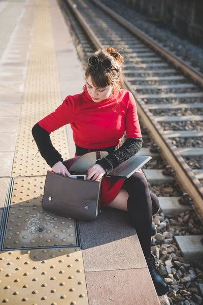 Hipster girl at train station — Stock Photo, Image