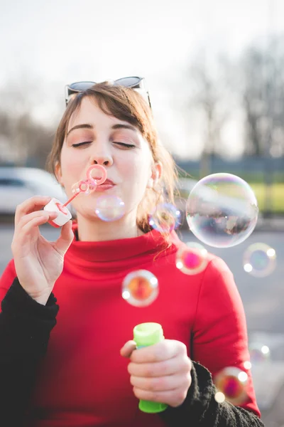 Женщина-хипстер, пускающая пузыри — стоковое фото
