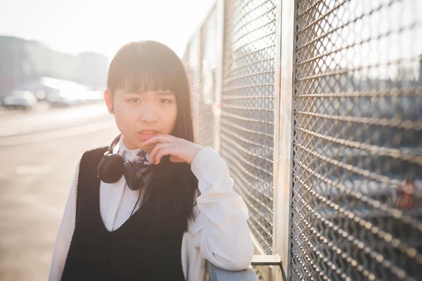 Młoda kobieta Azji ze słuchawkami — Zdjęcie stockowe