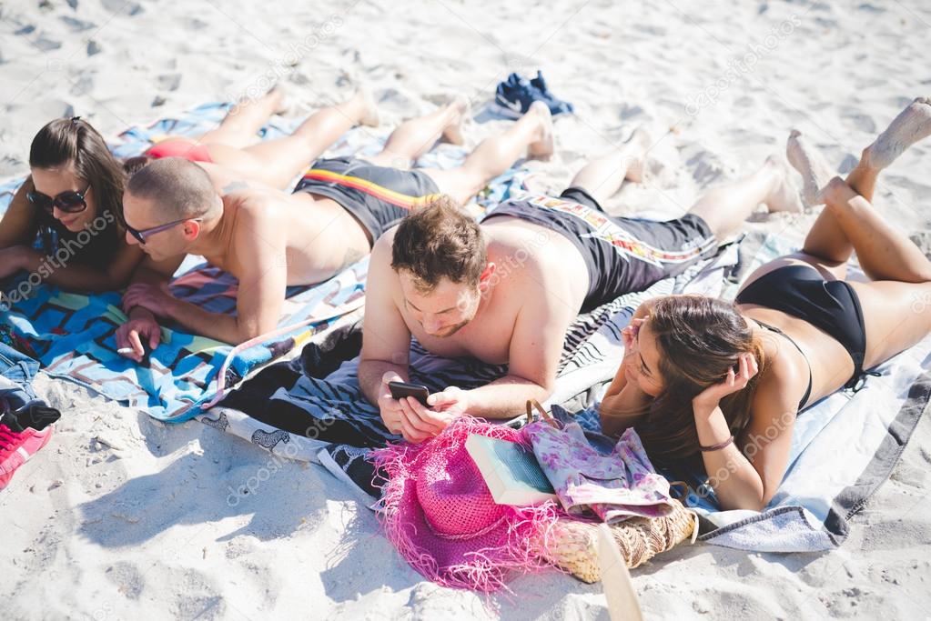 young friends on summer beach