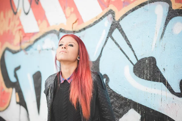 Young woman near graffiti wall — Stok fotoğraf