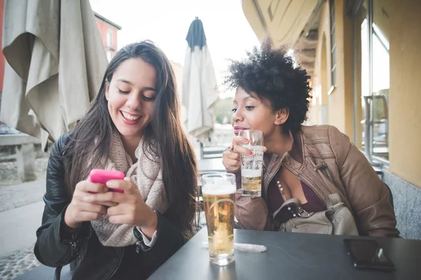 Two multiethnic beautiful young women in cafe — 스톡 사진