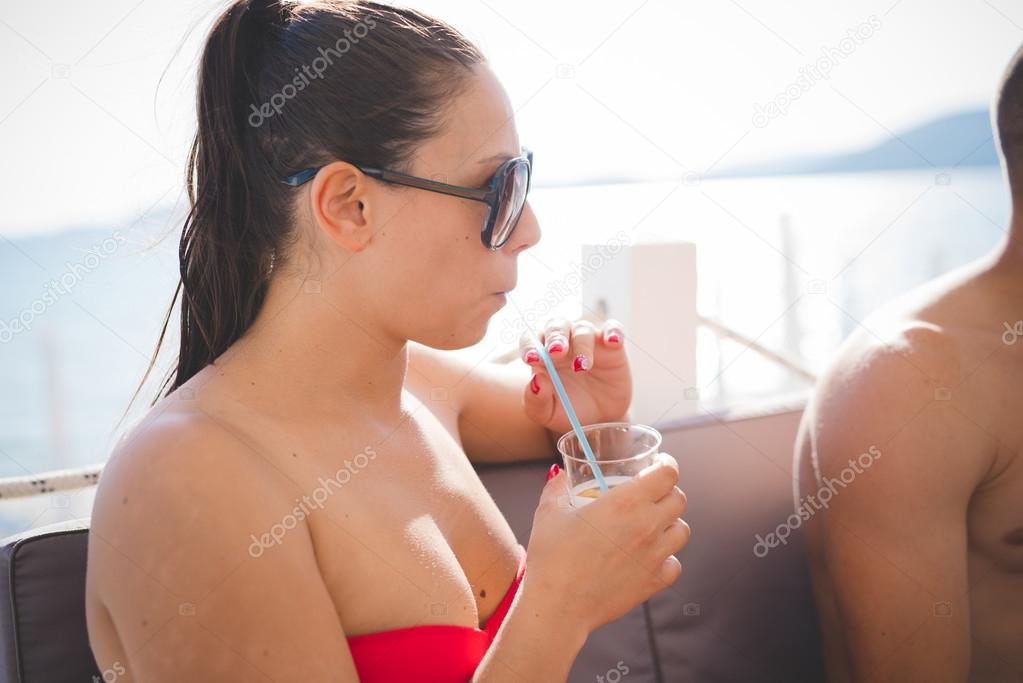 beautiful  woman drinking cocktail on beach