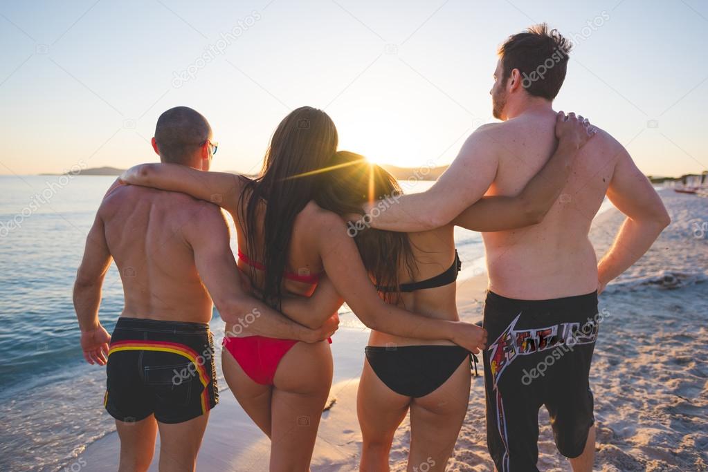 young friends on summer beach