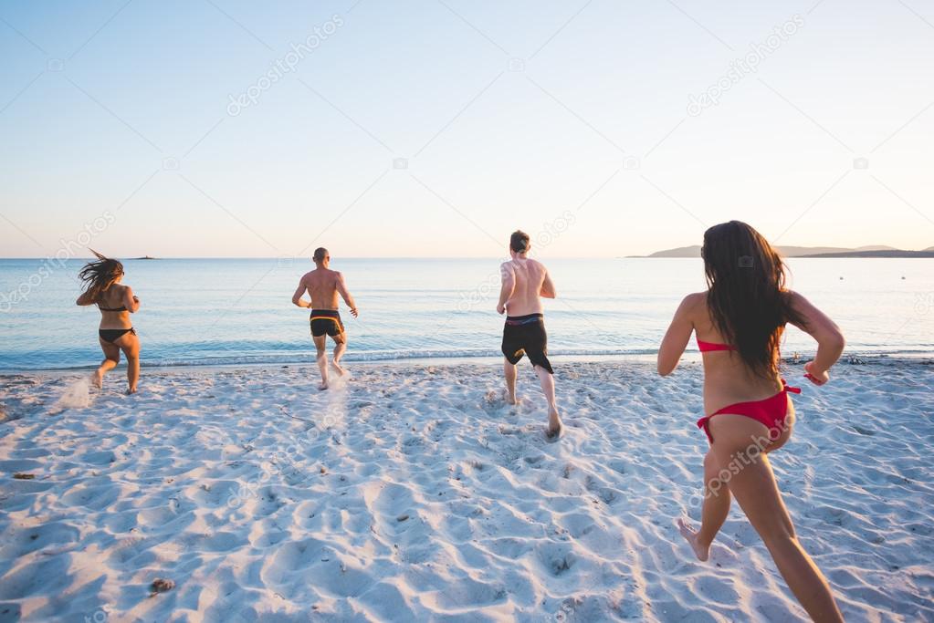 young friends on summer beach