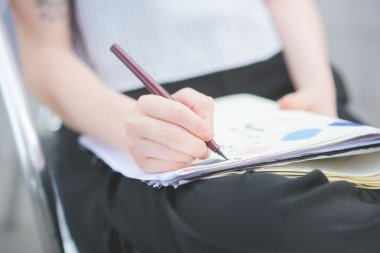 Woman drawing on a sketchbook