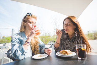 Young beautiful friends having an happy hour
