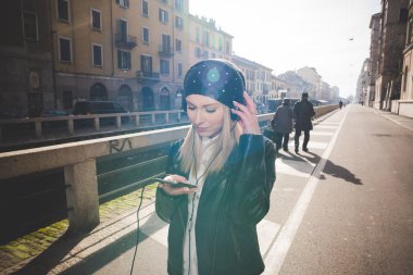 Blonde woman with headphones listening to music
