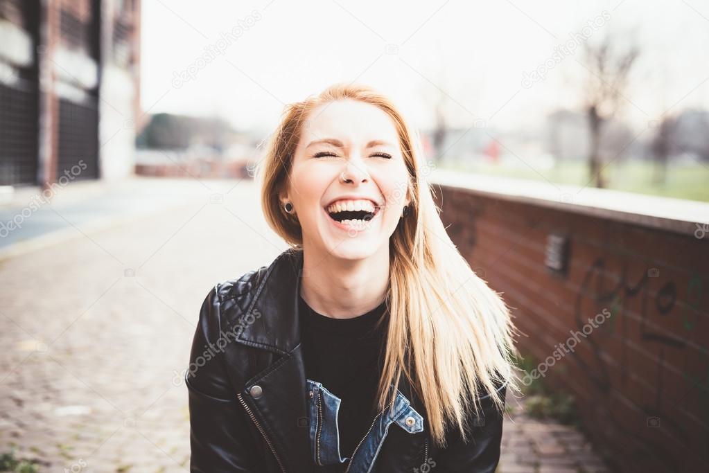 Blonde woman in the city laughing