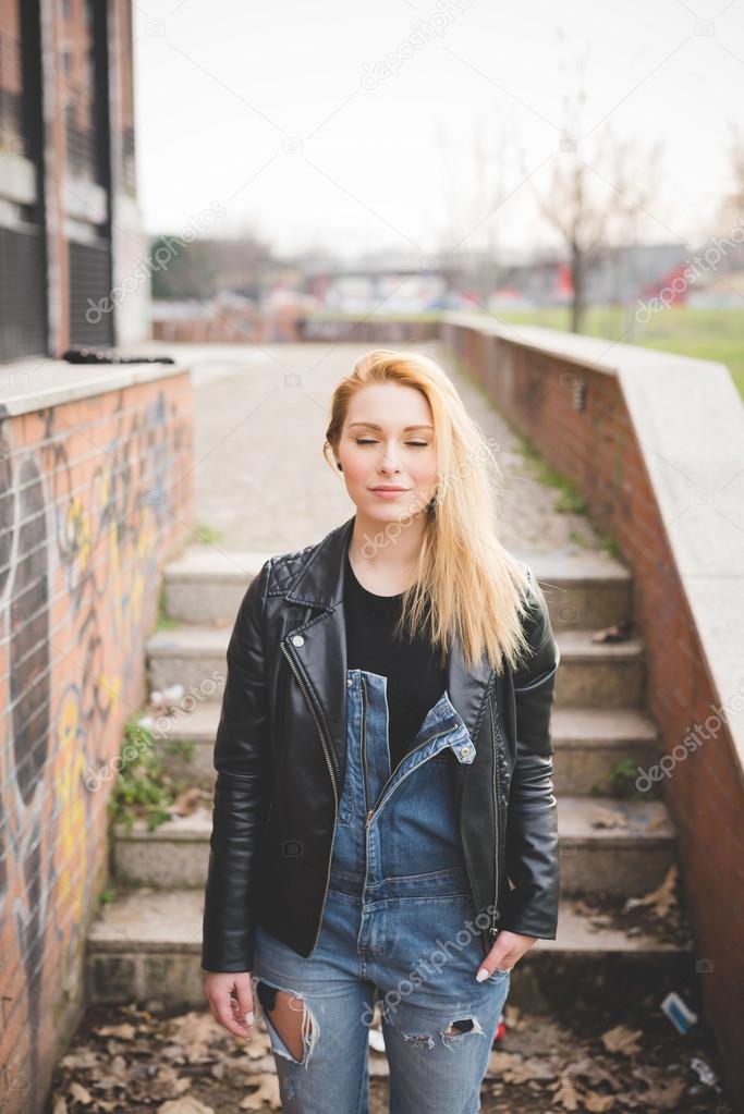 Young beautiful blonde woman in city