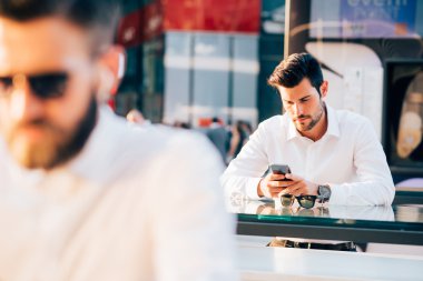 Young modern businessmen using smartphone