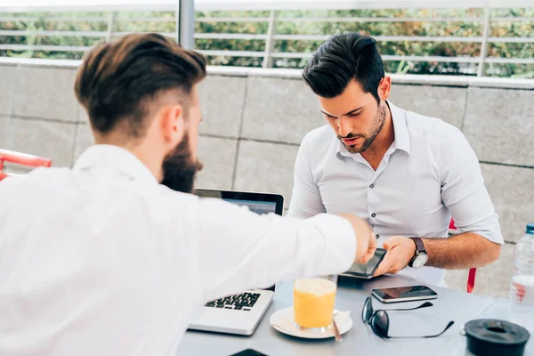 Modern businessmen using pc and tablet