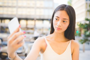 Asiatic woman taking selfie
