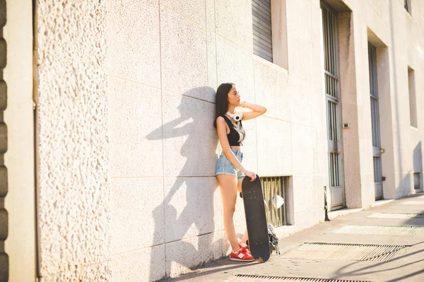 Asiatic skater woman with skateboard — Stok fotoğraf
