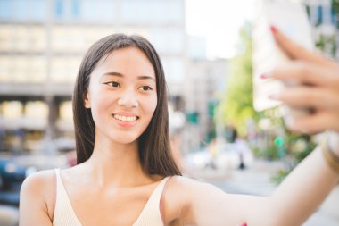 asiatic woman taking selfie