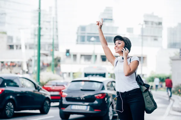 Young woman calling taxi — 图库照片