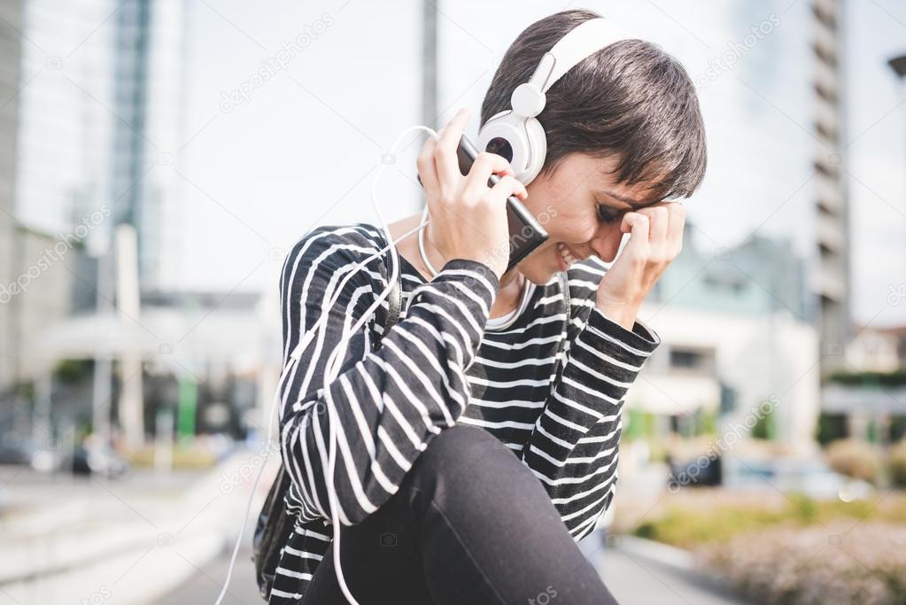 Young handsome woman listening music