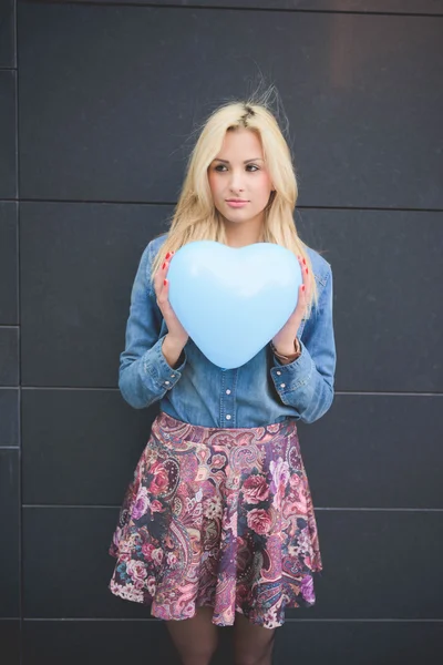 blonde girl with hearted balloon