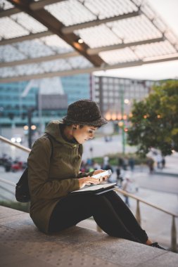 Woman holding smartphone and tablet