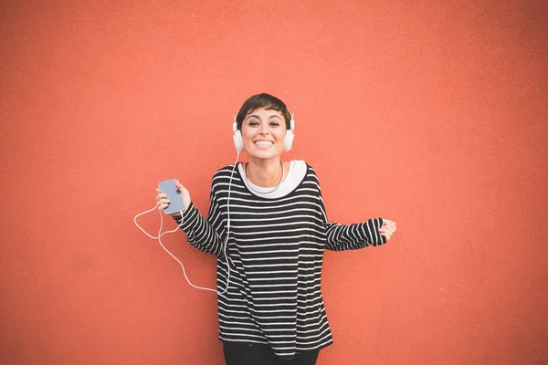 Женщина слушает музыку с наушниками Лицензионные Стоковые Фото