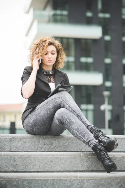 Businesswoman talking smartphone and using a tablet — Stock Photo, Image