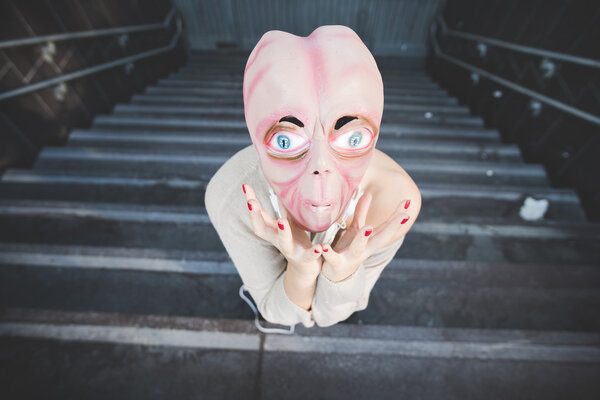 woman wearing an alien mask