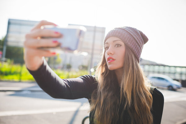 woman wearing hat taking selfie
