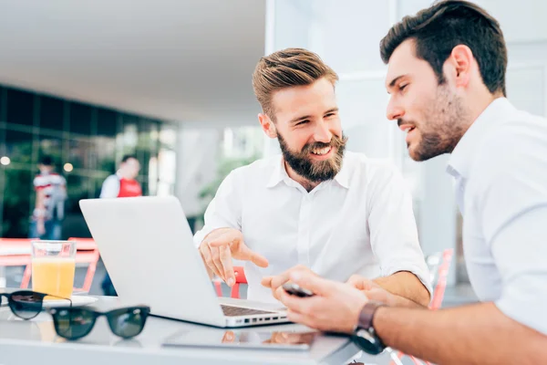 Affärsmän sitter i en bar med laptop — Stockfoto