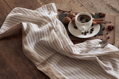 A cup of hot coffee and themed items around it.