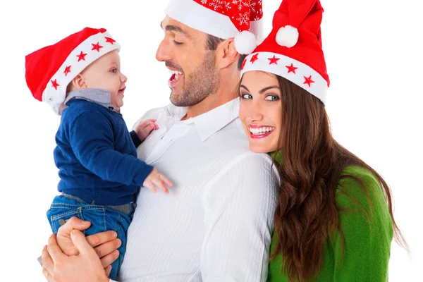 Padres felices con bebé niño usando sombreros de Santa Imagen de stock