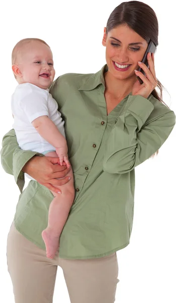 Happy mother carrying son while using mobile phone — Stock Photo, Image