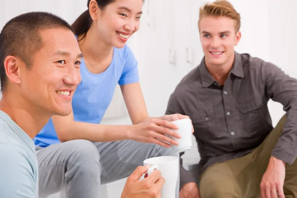 Diverse group of friends drinking coffee — Stock Photo, Image