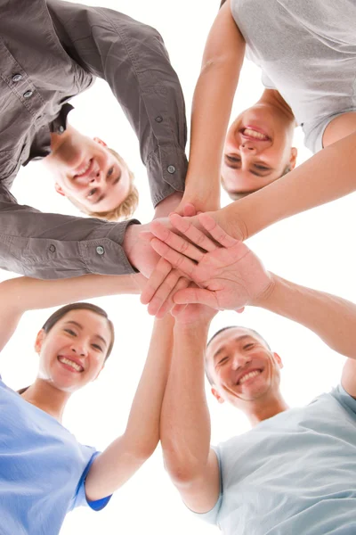 Happy businesspeople placing their hands top of each other — Stock Photo, Image