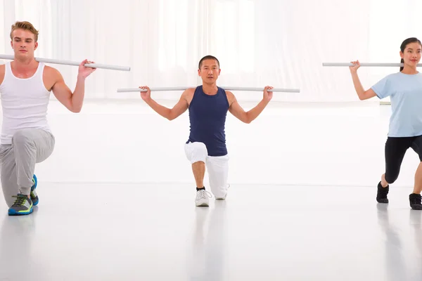 Diverse group of people exercising in gym — Stock Photo, Image