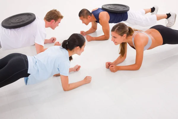 Unga multi etniska människor tränar i gym — Stockfoto