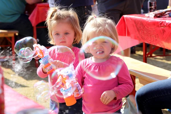 Small Sisters Playing with Bubbles at Festival South Africa