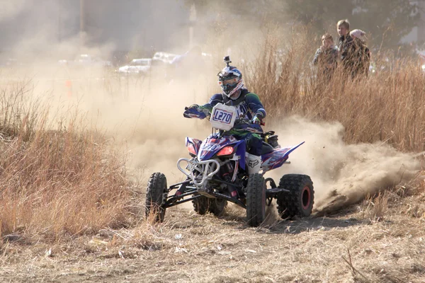 Quad Bike kicking up trail of dust on sand track during rally ra — Stok fotoğraf