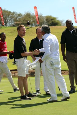 Tournament presenter and grand master Gary Player shaking hands 