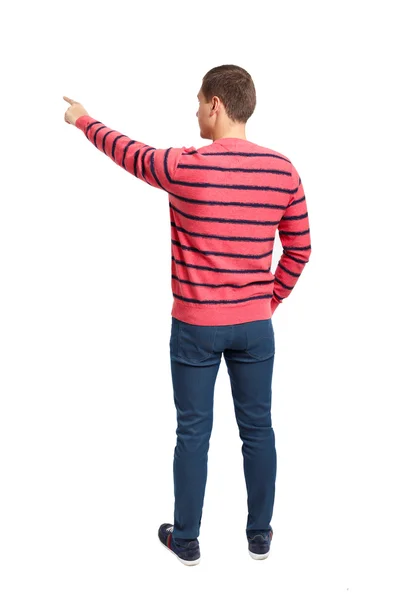 シャツとジーンズの若い男性を指しているの背面図 — ストック写真