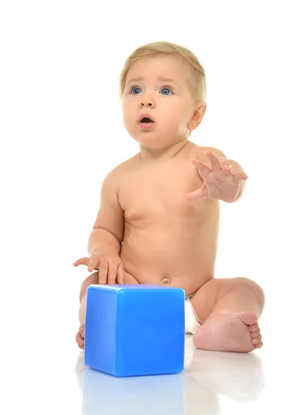 Infant child baby boy toddler playing holding blue bricks toy in — Stock Photo, Image