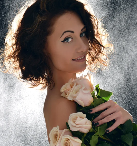 Beautiful curly hair woman with bouquet of wild roses flowers wi — Stock Photo, Image