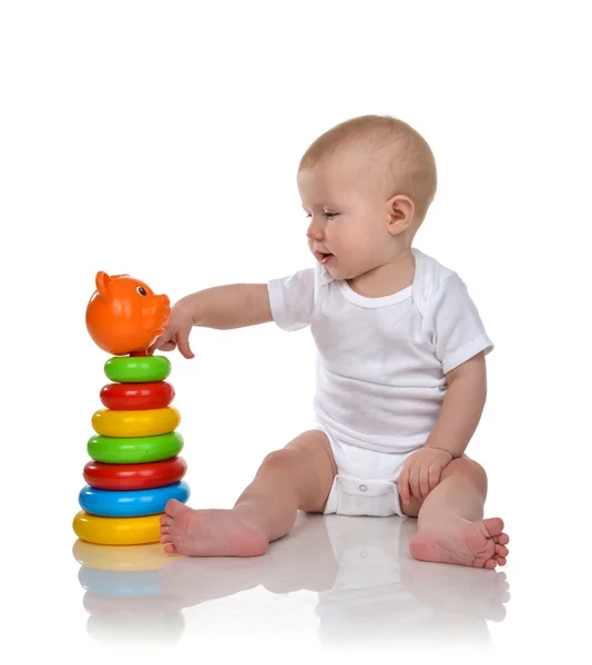 Infant child baby boy toddler playing with Pyramid in hand on a — Stock Photo, Image