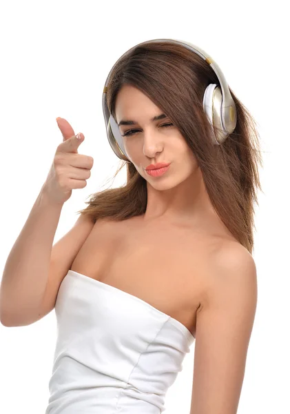 Brunette woman listening and enjoying music in gold headphones — Stock Photo, Image